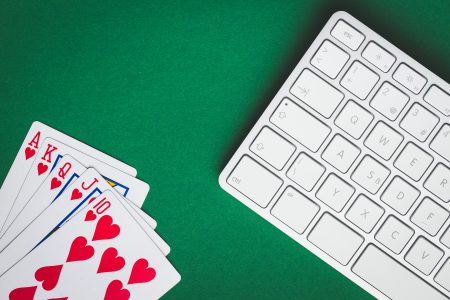 Concept of on-line poker game. Poker cards and keyboard.